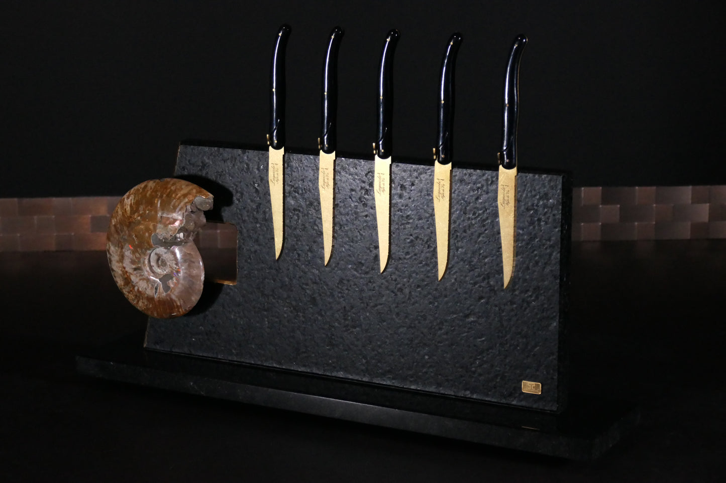 Knife block made of Nero Impala with gold plating and an ammonite