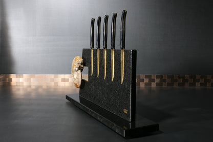 Knife block made of Nero Impala with gold plating and an ammonite