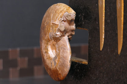 Knife block made of Nero Impala with gold plating and an ammonite