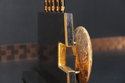 Knife block made of Nero Impala with gold plating and an ammonite